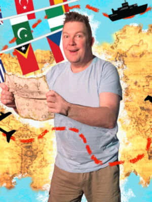 Craig holds a map in front of a backdrop containing a world map, various flags, a koala bear and a penguin.